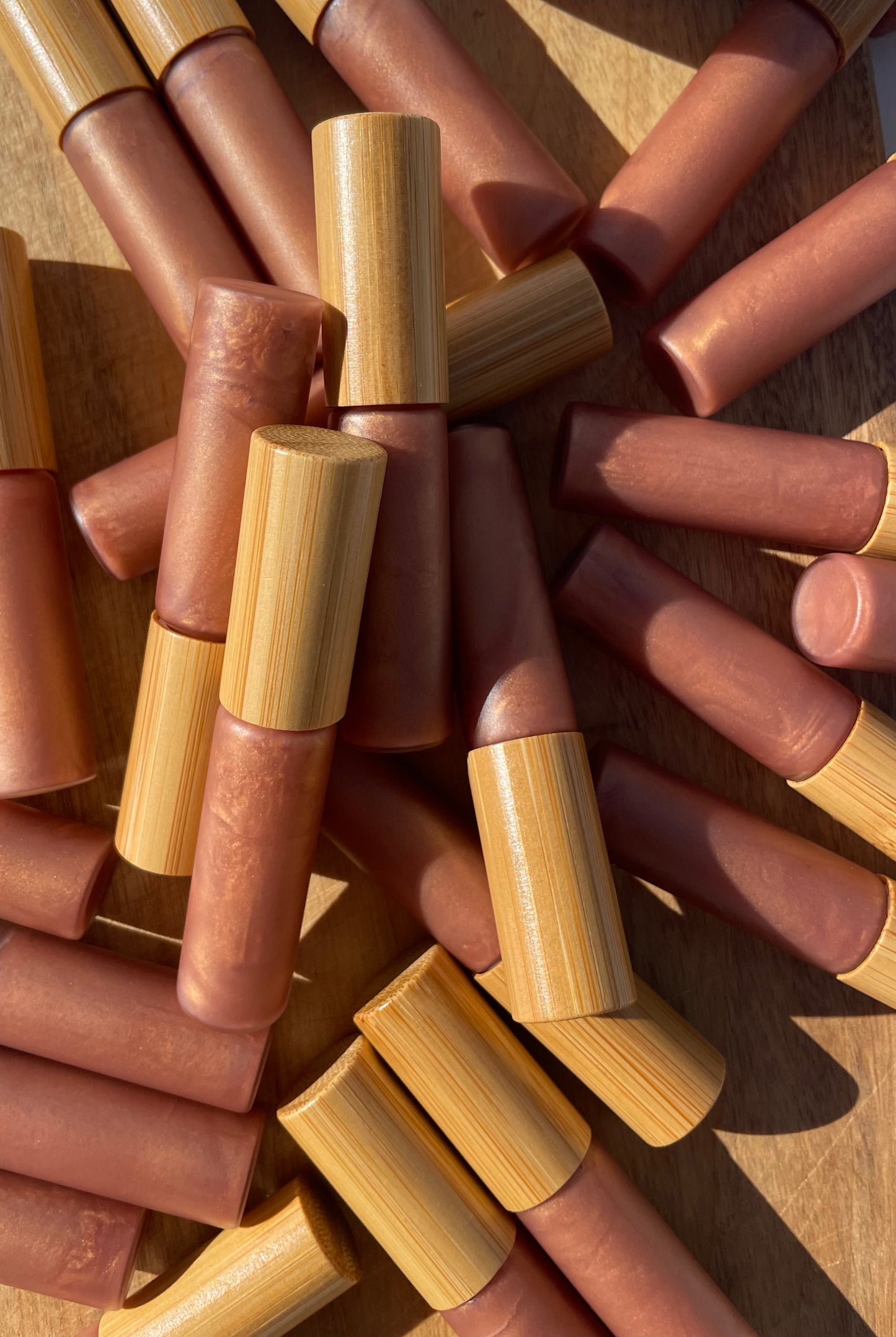 CastorSpell Strawberry Kisses natural castor oil lip gloss glass tube, unlabelled to show natural colour