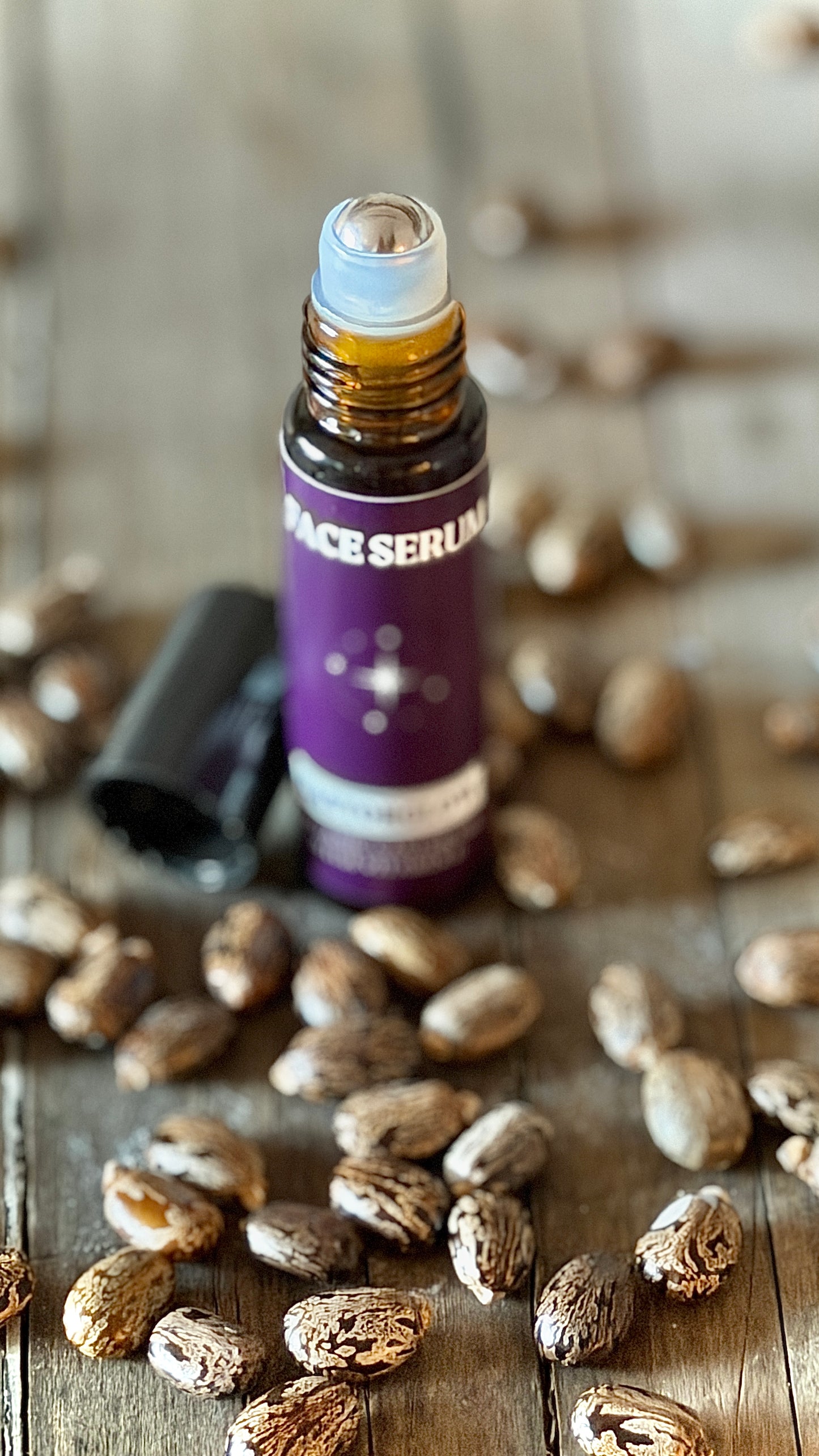 Close up stainless steel ball glass bottle 10ml CastorSpell organic castor oil face serum travel roller