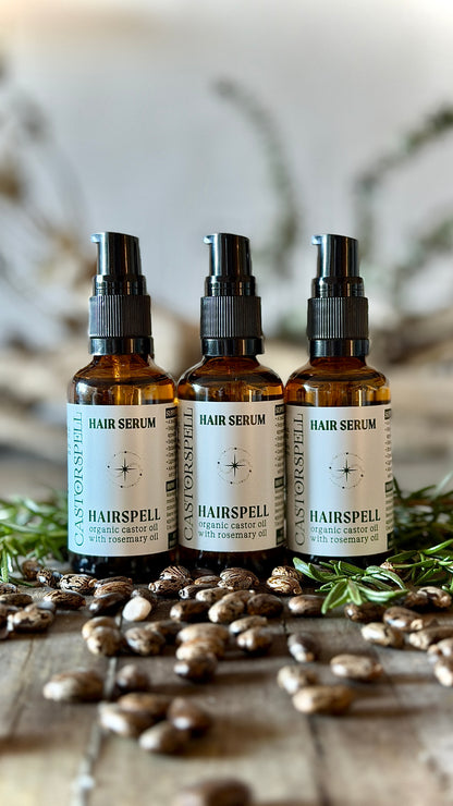 Three bottles of Hairspell hair serum on a wooden surface with rosemary, amber glass bottles 50mL
