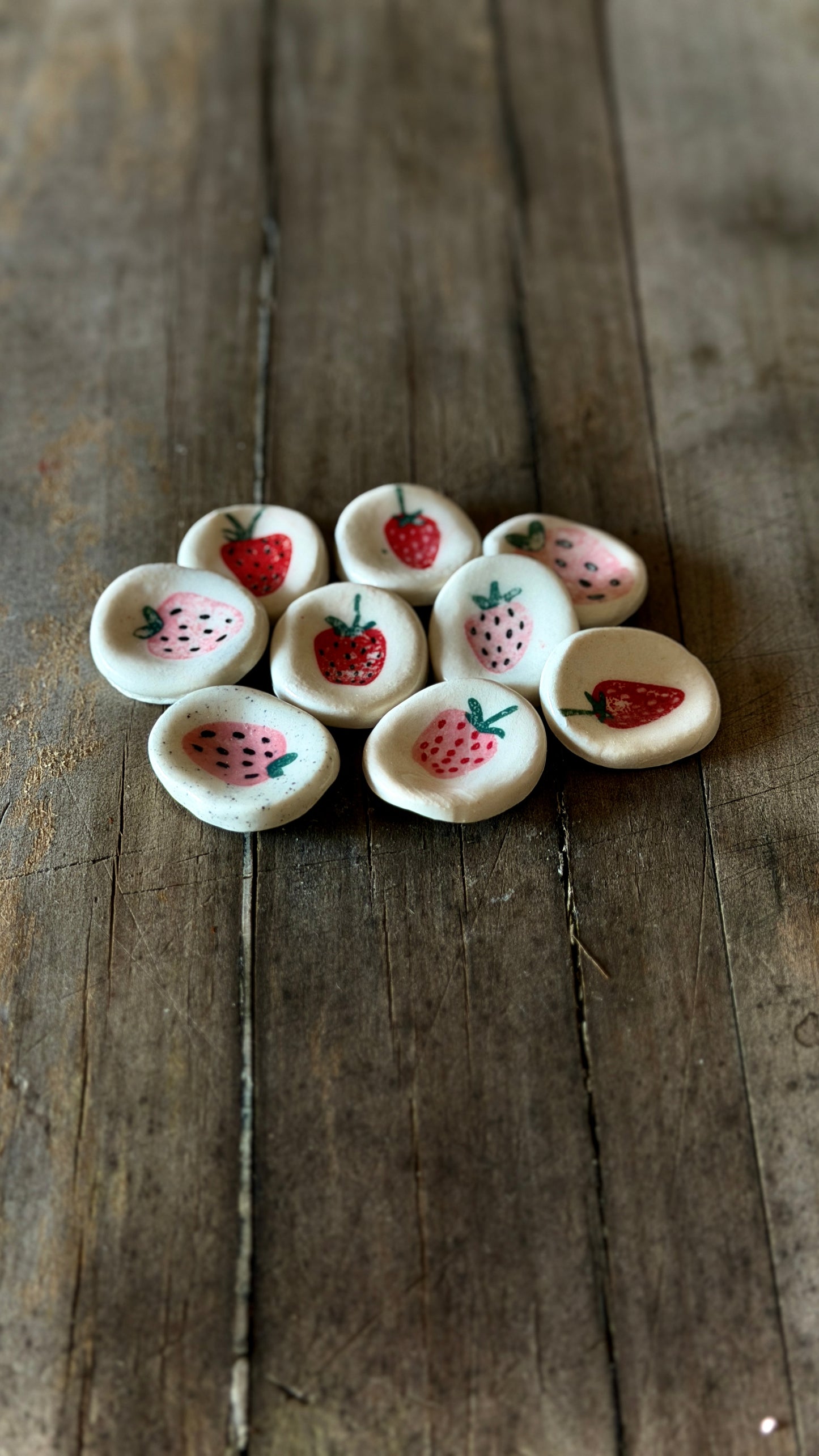 Handmade ceramic strawberry worry stone for grounding and mindfulness.