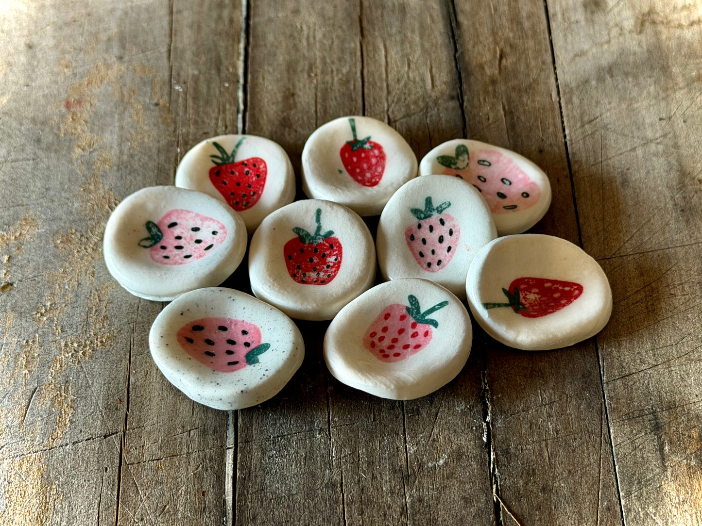 Collection of handmade strawberry worry stones crafted for calming rituals.