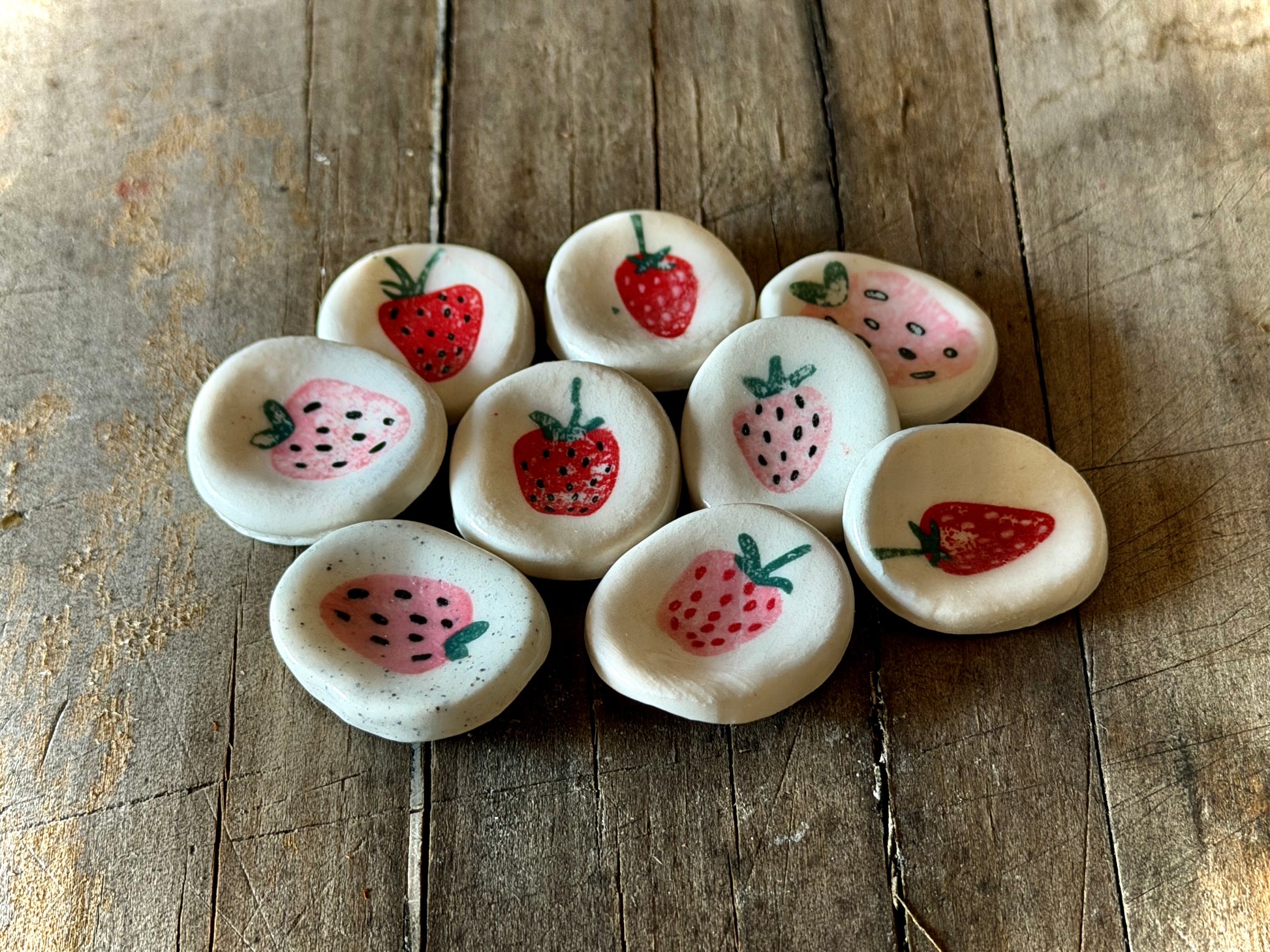 Collection of handmade strawberry worry stones crafted for calming rituals.